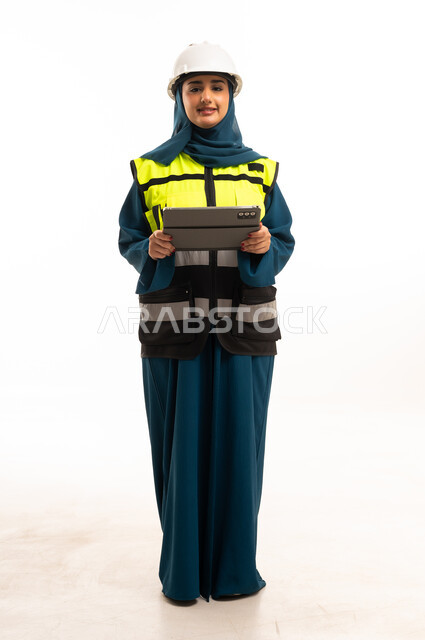 Saudi Female Engineer in Safety Gear with Tablet