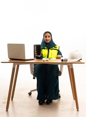 Saudi Female Engineer with Smartphone at Office Desk