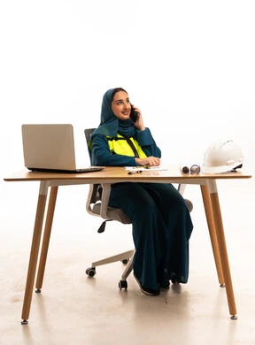 Saudi Female Engineer Talking on Phone at Desk