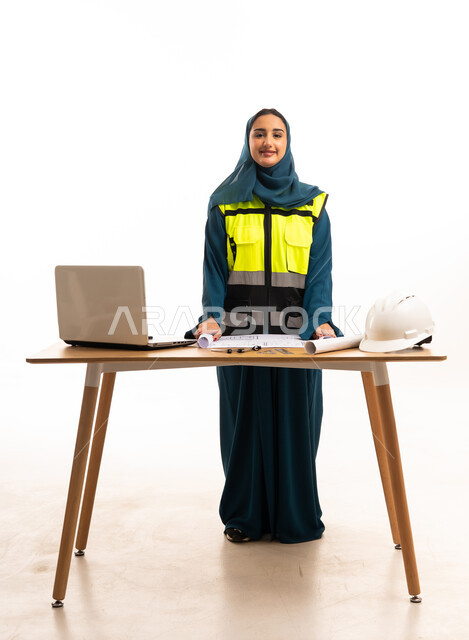 Saudi Female Engineer with Safety Vest and Blueprints