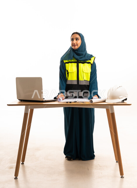 Saudi Female Civil Engineer with Blueprints and Hard Hat