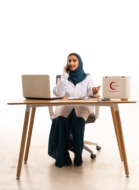 Saudi Female Doctor on Phone at Office Desk