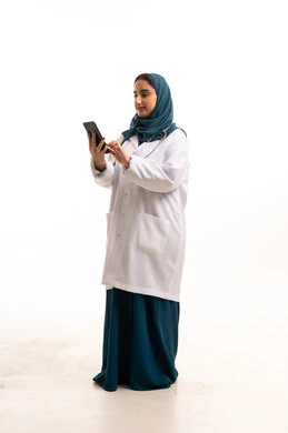 Saudi Female Doctor Using Digital Tablet in White Coat