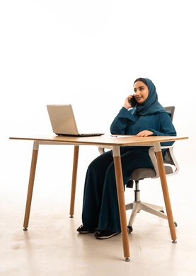Saudi Businesswoman in Abaya Using Smartphone at Desk