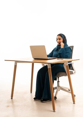 Saudi Woman in Abaya Working on Laptop with Headset
