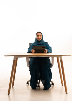 Saudi Businesswoman in Abaya with Tablet at Desk