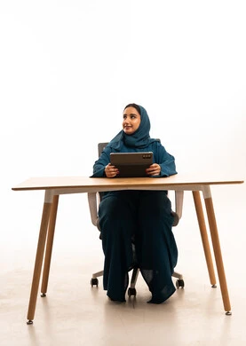 Saudi Woman with Tablet at Modern Office Desk