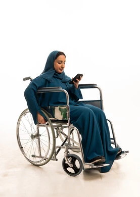 Saudi Woman in Wheelchair Using Smartphone