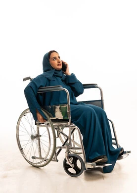 Saudi Woman in Wheelchair Using Smartphone