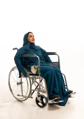Saudi Woman in Wheelchair Wearing Teal Abaya
