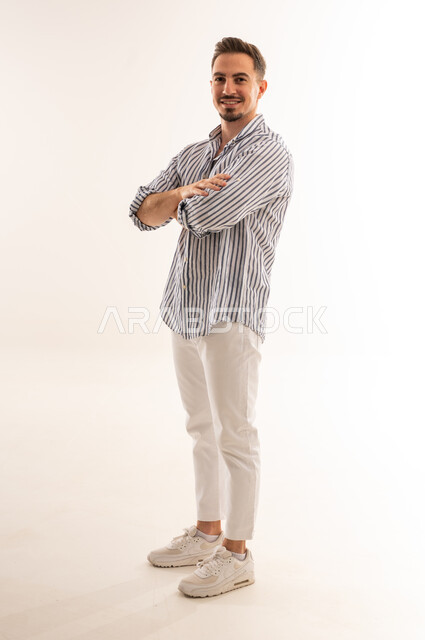 Saudi Man Standing in Studio with Arms Crossed
