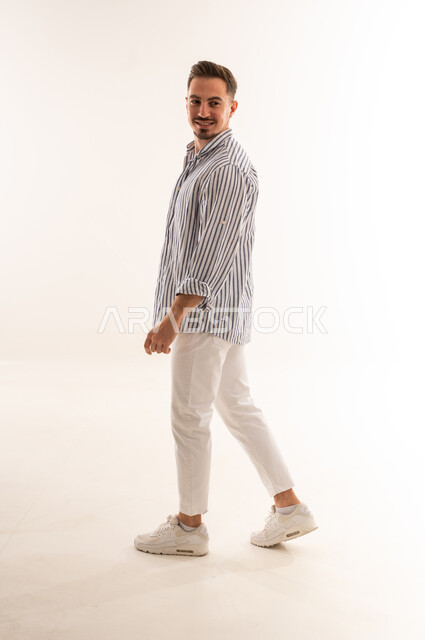 Saudi Man Walking in Studio on White Background