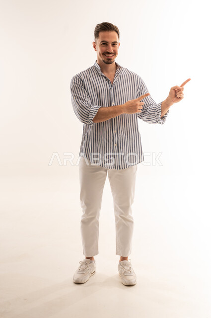 Smiling Saudi Man Pointing on White Background