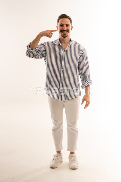 Saudi Man Pointing at Cheek on White Background