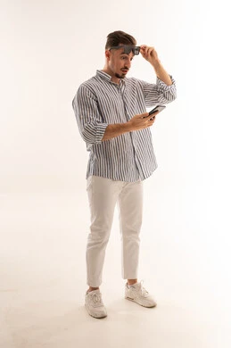 Surprised Saudi Man Looking at Smartphone in Studio