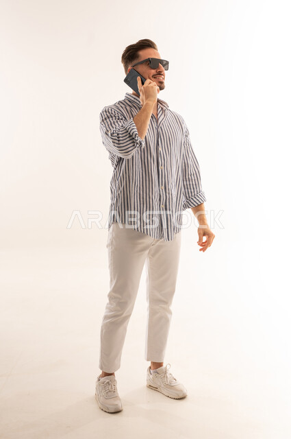 Saudi Man Talking on Smartphone in Studio Shot