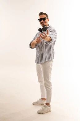Saudi Man in White Studio with Headphones and Sunglasses