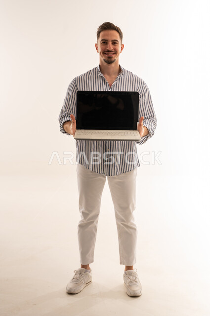 Saudi Man Holding Laptop on White Background
