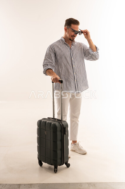 Saudi Man Traveler with Suitcase in Studio