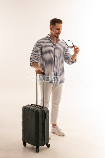 Saudi Man with Suitcase and Sunglasses on White Background