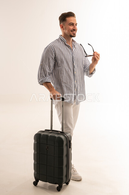 Saudi Man with Suitcase Travel Concept White Studio