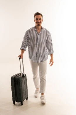 Saudi Man Walking with Travel Suitcase in Studio