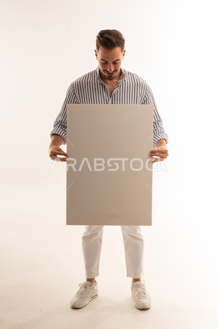 Saudi Man Holding Large Blank White Board in Studio