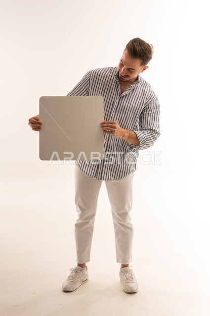 Saudi Man Holding Blank White Board in Studio
