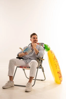 رجل سعودي على كرسي بحر مع عوامة صيفية