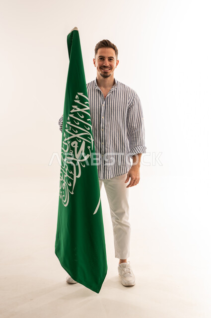 Saudi Man Holding Saudi Arabia Flag on White Background