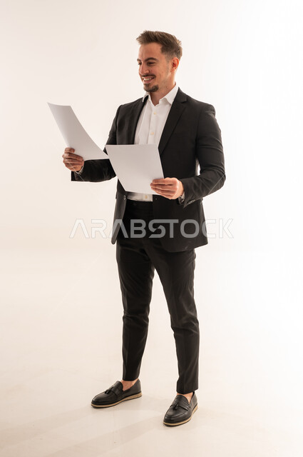 Saudi Businessman Holding Documents on White Background