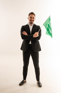 Saudi Businessman Holding National Flag in Studio