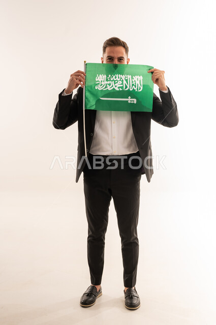 Saudi Man Holding Kingdom of Saudi Arabia Flag