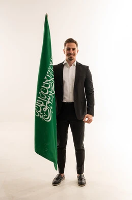 Saudi Man in Black Suit Holding Saudi Arabian Flag