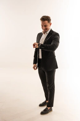 Saudi Businessman in Black Suit Checking Watch on White