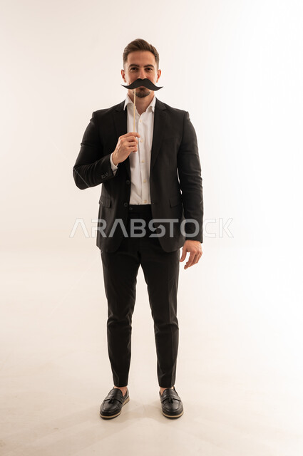 Saudi Businessman with Paper Mustache Prop in Studio