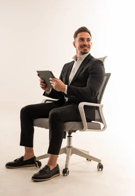 Saudi Businessman Sitting with Tablet on White Background