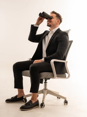 Saudi Businessman with Binoculars in Office Chair