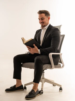Saudi Businessman Reading Book on Office Chair
