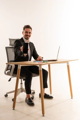 Saudi Businessman Holding Smartphone at Office Desk