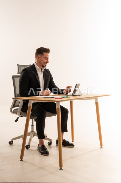 Saudi Businessman Using Digital Tablet in Studio