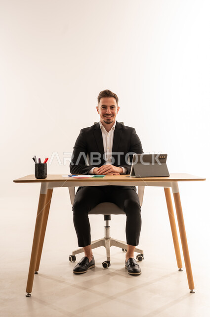 Saudi Businessman Sitting at Modern Office Desk