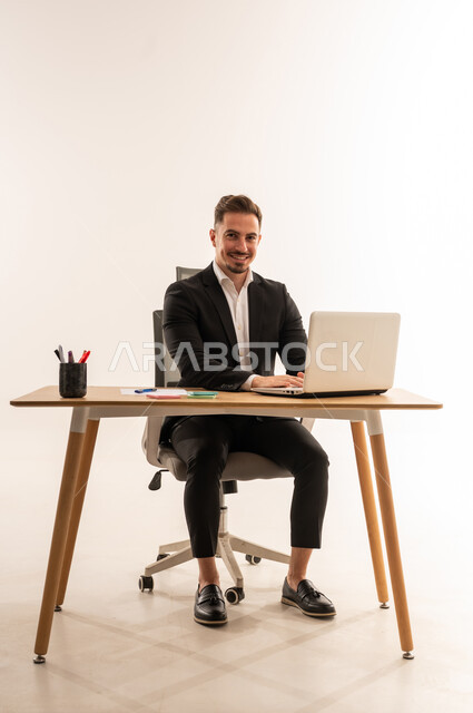Saudi Businessman at Desk with Laptop White Background