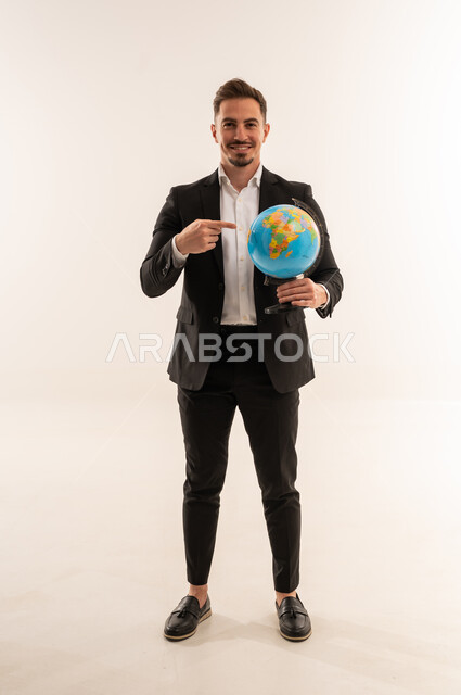 Saudi Businessman Holding Globe on White Background