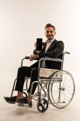 Saudi Businessman in Wheelchair Holding Blank Smartphone
