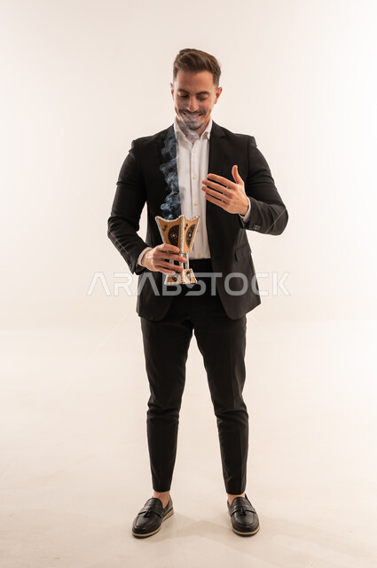 Saudi Man in Suit Holding Traditional Incense Burner