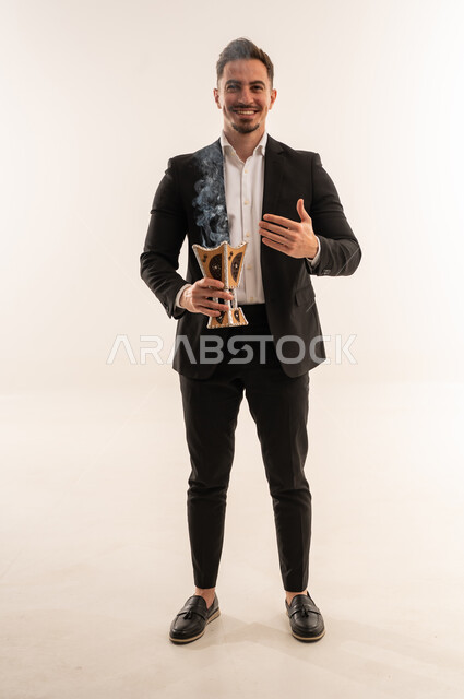 Saudi Man in Suit Holding Traditional Incense Burner