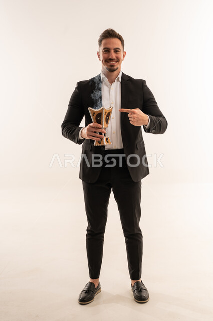 Saudi Man in Suit Holding Traditional Incense Burner