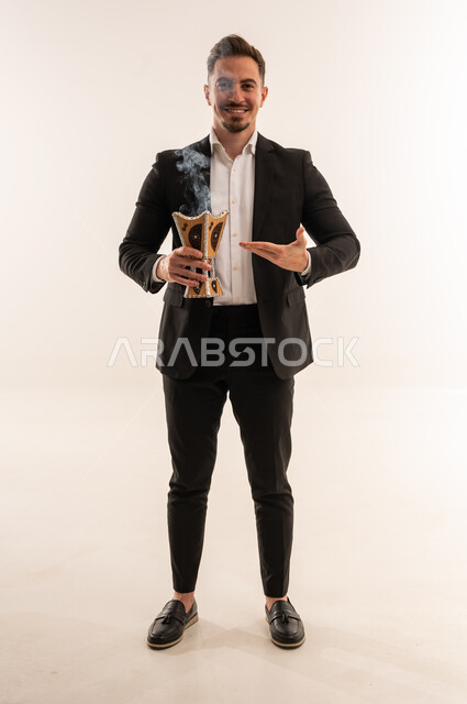 Saudi Man in Suit Holding Traditional Incense Burner