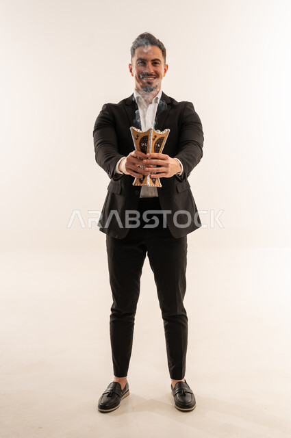 Saudi Man in Suit Holding Traditional Incense Burner